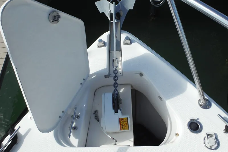 Slide: The Image of 2005 Chaparral Signature 350 boat anchor compartment with open hatch and chain. - 10