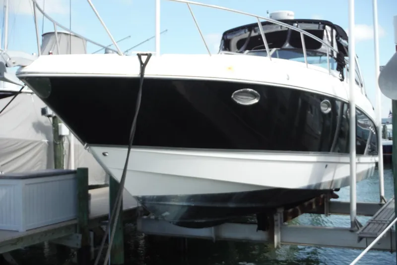 Slide: The Image of 2005 Chaparral Signature 350 yacht docked at marina, black and white hull visible. - 49