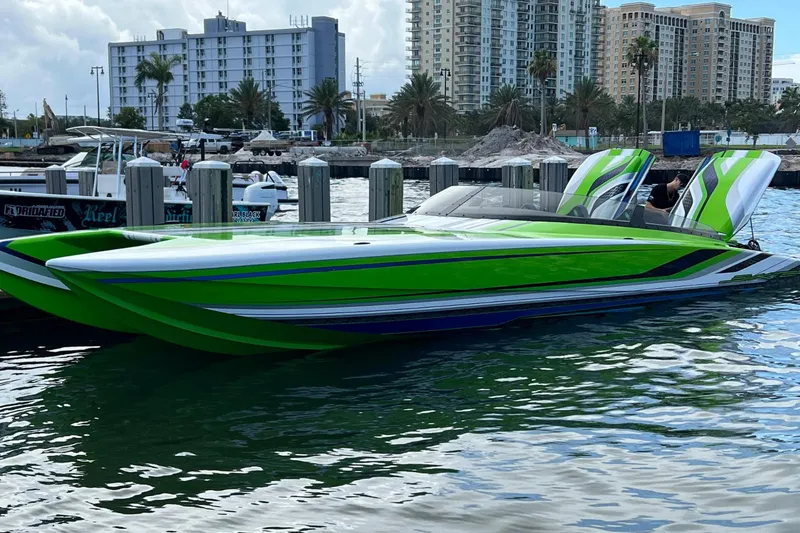 Slide: The Image of Green Skater 388 speedboat docked in a marina, 2025 model, with cityscape background. - 13