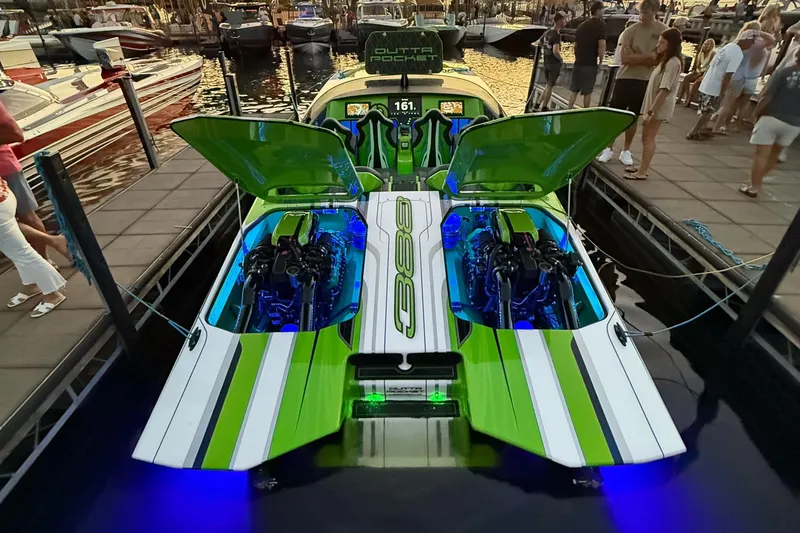 Slide: The Image of Futuristic Skater 388 speedboat with open engine compartments, docked at sunset, 2025 model. - 16