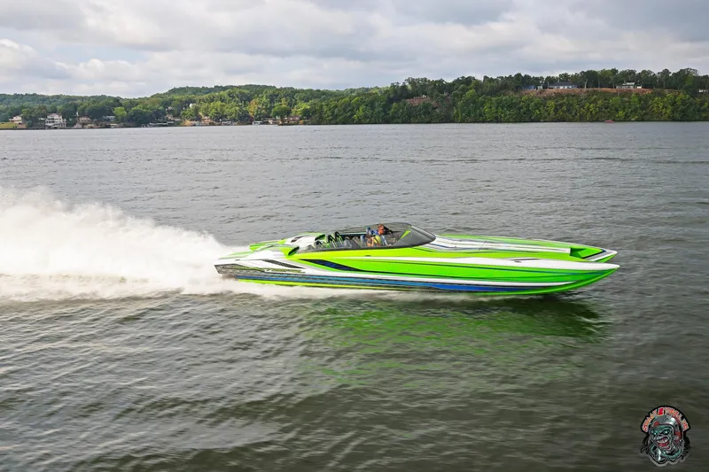 Slide: The Image of High-speed Skater 388 powerboat cruising on a lake, 2025 model, vibrant green design. - 25