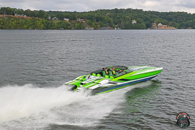 Slide: The Image of High-speed Skater 388 powerboat cruising on a lake, 2025 model, vibrant green design. - 26