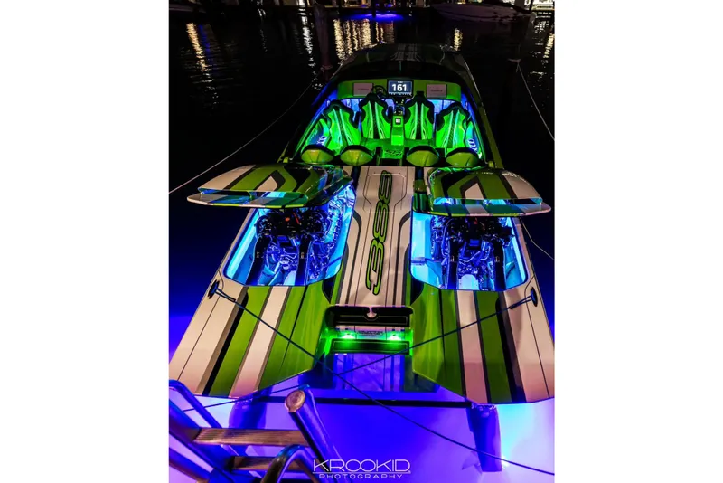 Slide: The Image of 2025 Skater 388 boat with vibrant green and blue lighting, showcasing powerful engines. - 5
