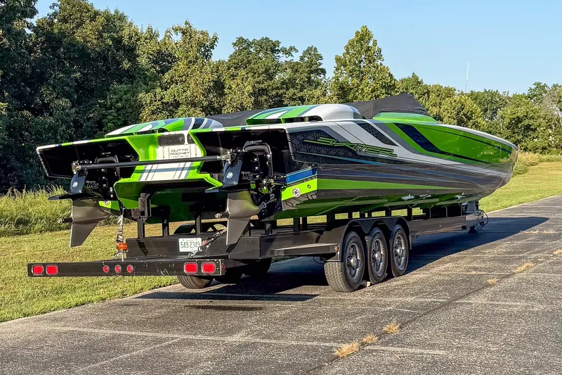 Slide: The Image of 2025 Skater 388 powerboat on trailer, vibrant green and black design, parked outdoors. - 18