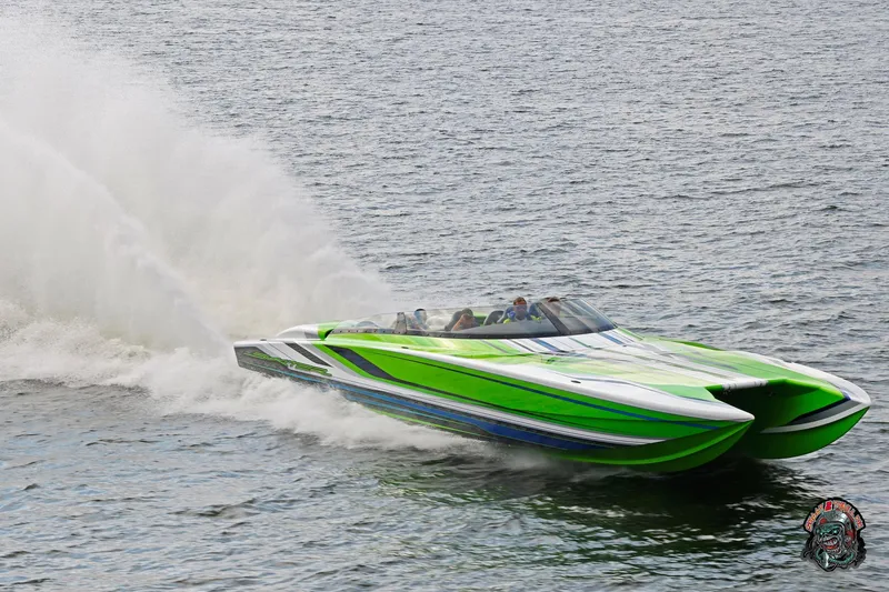 Slide: The Image of High-speed Skater 388 powerboat from 2025, featuring vibrant green and blue design on water. - 27