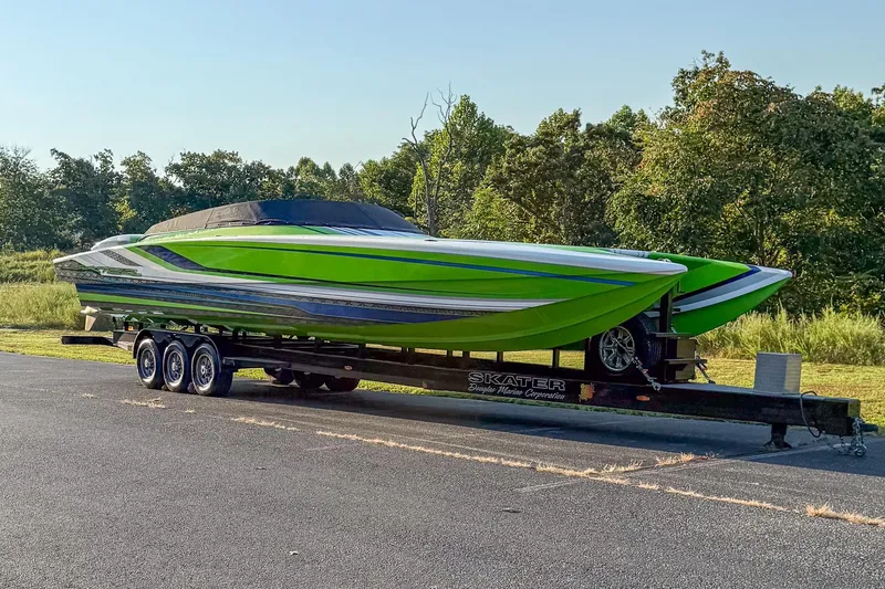 Slide: The Image of Green Skater 388 speedboat on trailer, 2025 model, parked outdoors. - 20