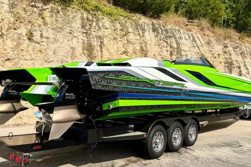 Slide: The Image of 2025 Skater 388 powerboat with vibrant green and blue design on a trailer. - 12