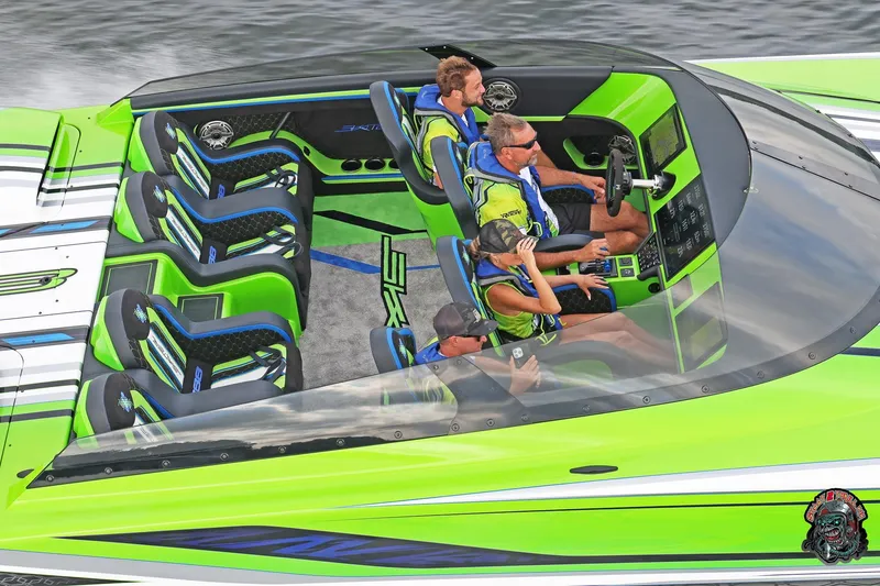 Slide: The Image of High-performance Skater 388 speedboat, 2025 model, with vibrant green and blue interior design. - 23