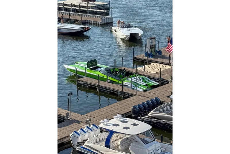 Slide: The Image of A vibrant green 2025 Skater 388 boat docked at a marina with other boats nearby. - 9