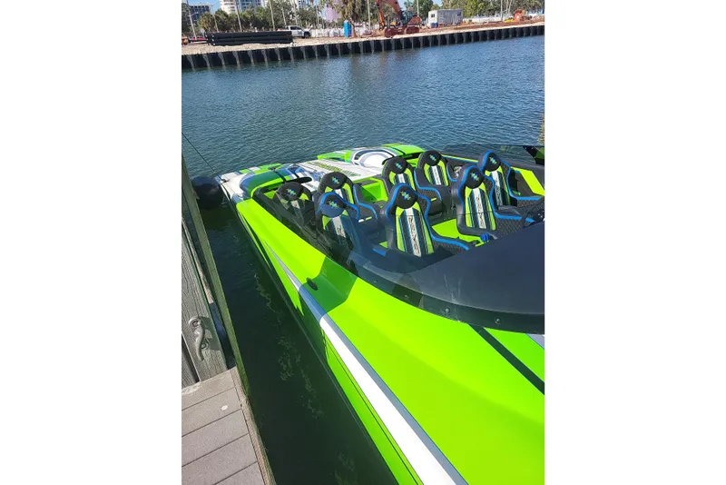 Slide: The Image of Bright green Skater 388 speedboat docked, 2025 model, featuring sporty seating and sleek design. - 7