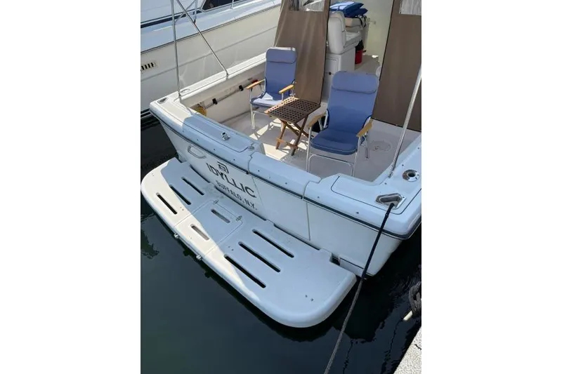 Slide: The Image of 2002 Tiara 29 boat with seating area and table on deck, docked at marina. - 20