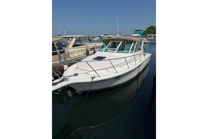 Slide: The Image of 2002 Tiara 29 boat docked in marina under clear blue sky. - 5