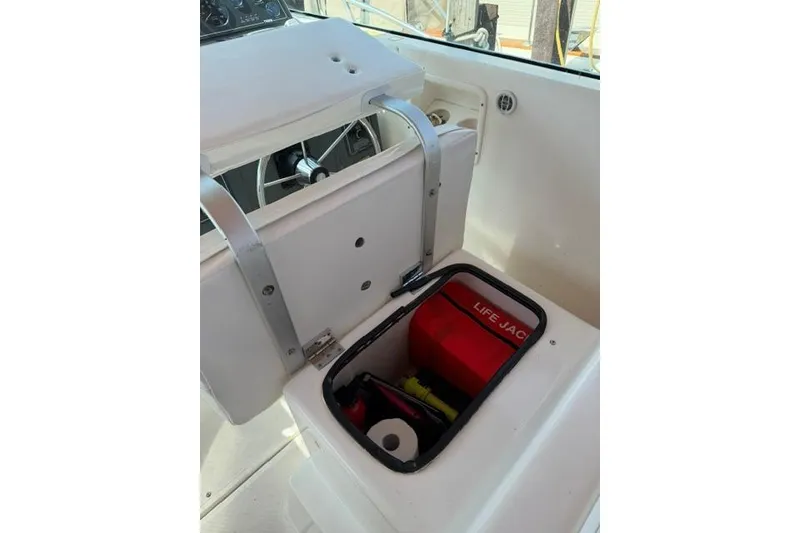 Slide: The Image of Storage compartment on a 2002 Tiara 29 boat with life jacket and safety gear. - 7