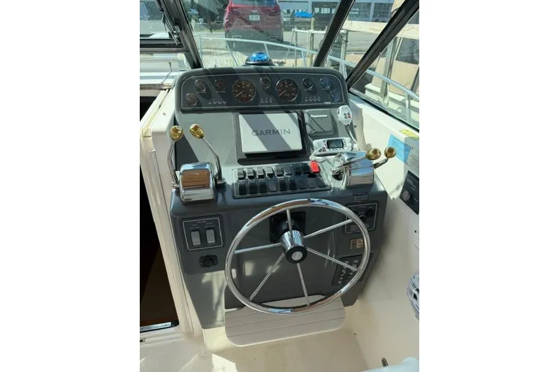 Slide: The Image of Helm of 2002 Tiara 29 boat with Garmin navigation system and steering wheel. - 16