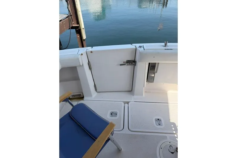 Slide: The Image of 2002 Tiara 29 boat deck with blue chair and water view. - 17