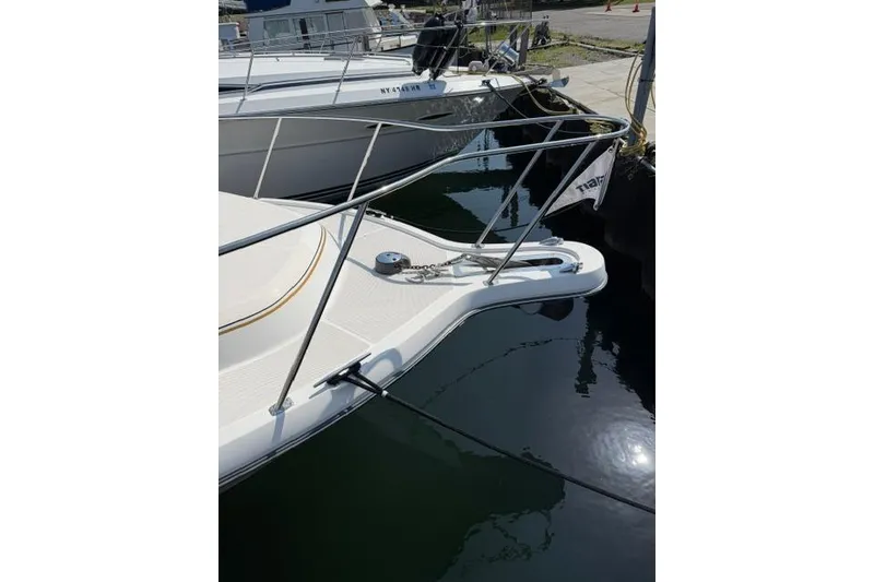 Slide: The Image of Bow of a 2002 Tiara 29 boat docked at a marina. - 2