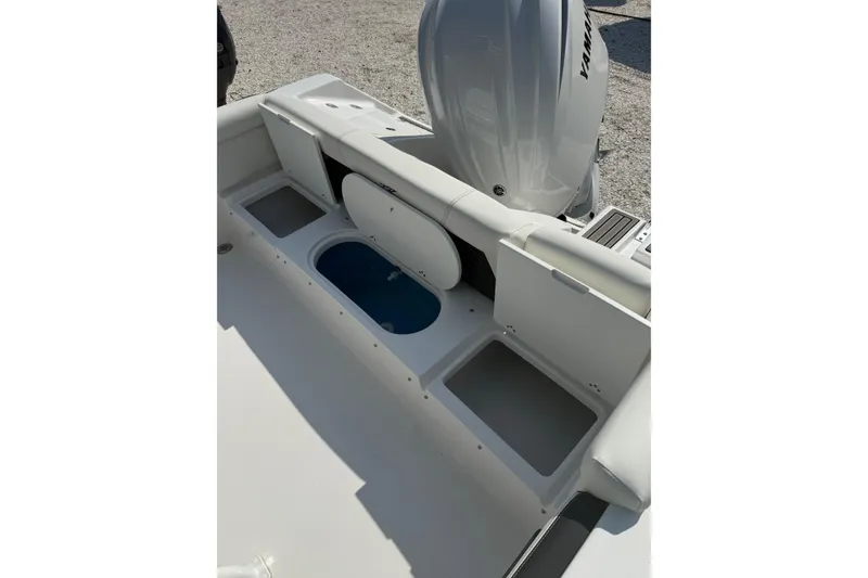 Slide: The Image of 2027 Tidewater 220 LXF boat interior with storage compartments and Yamaha engine. - 8