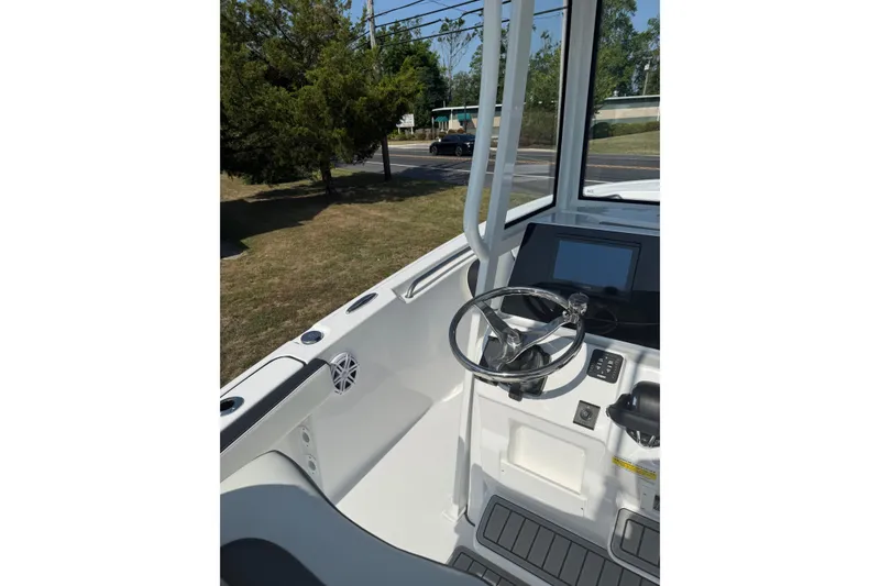 Slide: The Image of Steering console of 2027 Tidewater 220 LXF boat with modern controls and display. - 10