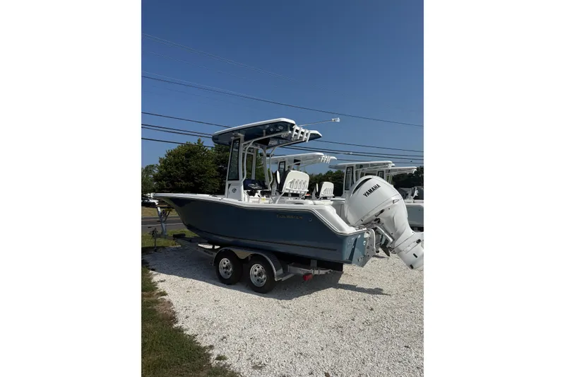 The Image of 2027 Tidewater 220 LXF boat on trailer with Yamaha engine, parked outdoors. - 1