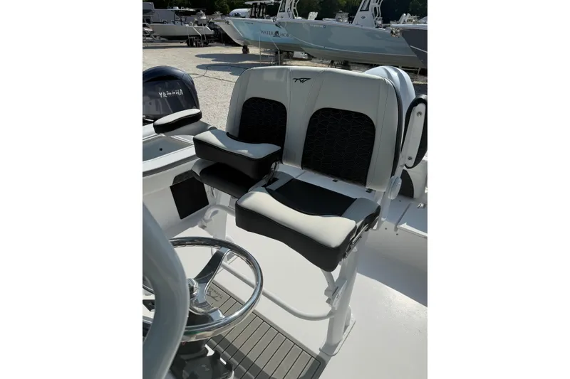 Slide: The Image of 2027 Tidewater 220 LXF boat interior with dual seats and steering wheel. - 7