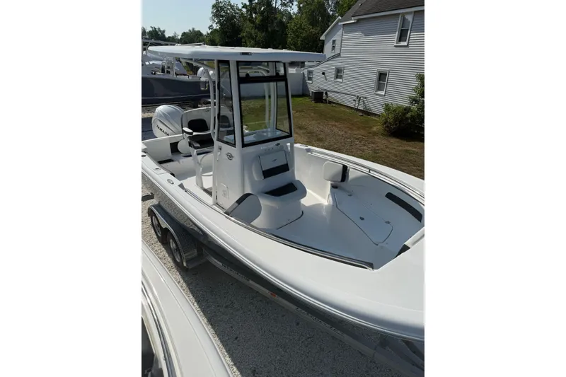 Slide: The Image of 2027 Tidewater 220 LXF boat with Yamaha engine, parked on a trailer. - 12