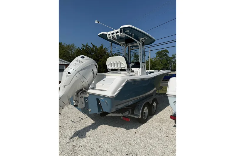 Slide: The Image of 2027 Tidewater 220 LXF boat with Yamaha engine on trailer, parked outdoors. - 13