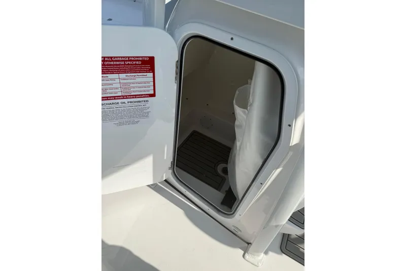 Slide: The Image of Open storage compartment on 2027 Tidewater 220 LXF boat, featuring interior details. - 6