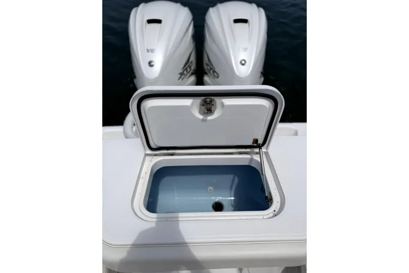 Slide: The Image of Open storage compartment on 2021 Jupiter 38 HFS boat with twin outboard engines. - 11