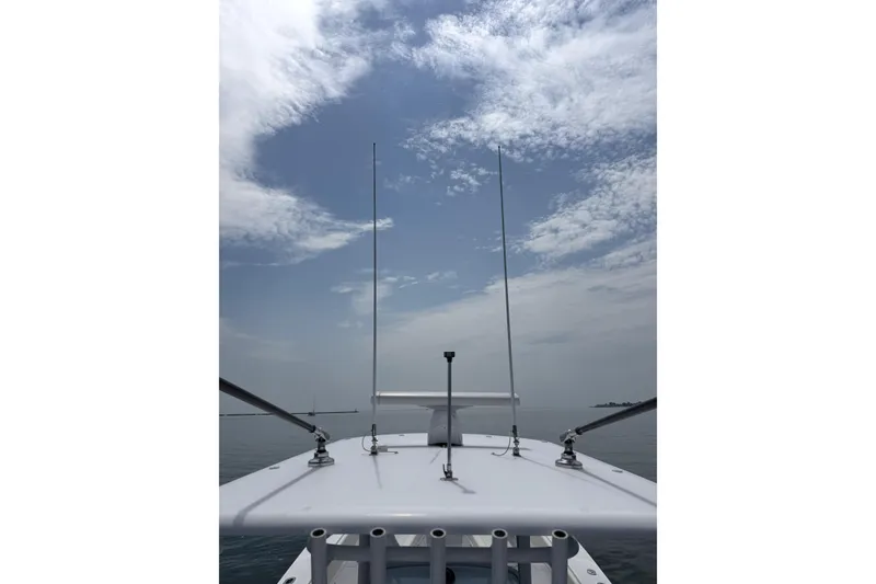 Slide: The Image of 2021 Jupiter 38 HFS boat deck with antennas under a partly cloudy sky. - 12