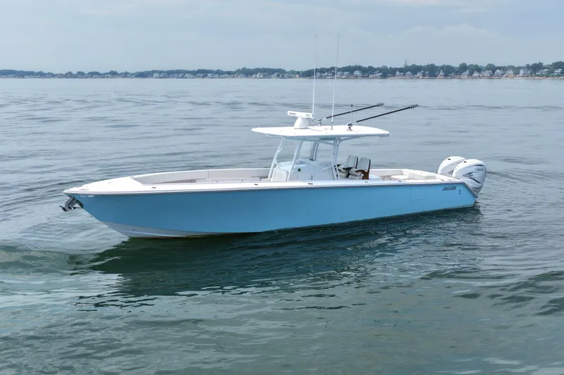 Slide: The Image of 2021 Jupiter 38 HFS boat on calm water, showcasing sleek design and twin engines. - 3