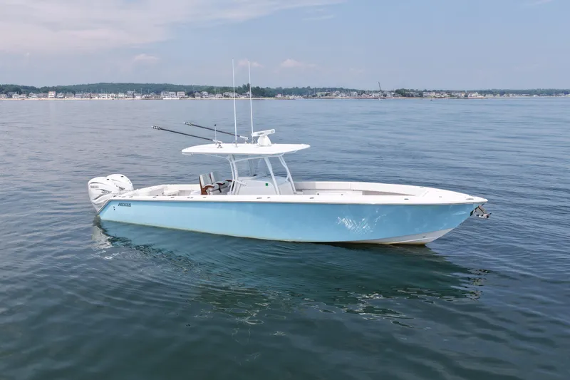 Slide: The Image of 2021 Jupiter 38 HFS boat on calm water, clear sky, distant shoreline. - 4