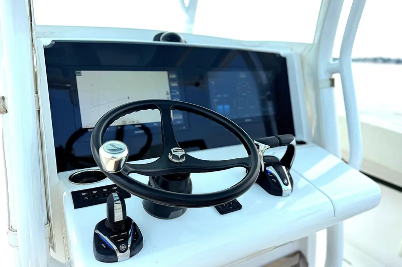 Slide: The Image of Helm of 2021 Jupiter 38 HFS boat with modern controls and navigation screens. - 8
