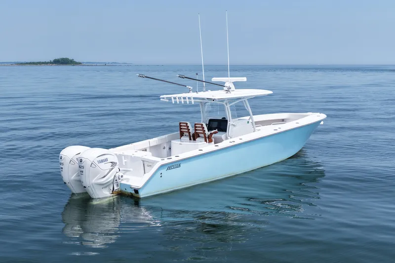Slide: The Image of 2021 Jupiter 38 HFS boat with twin Yamaha engines on calm ocean waters. - 1