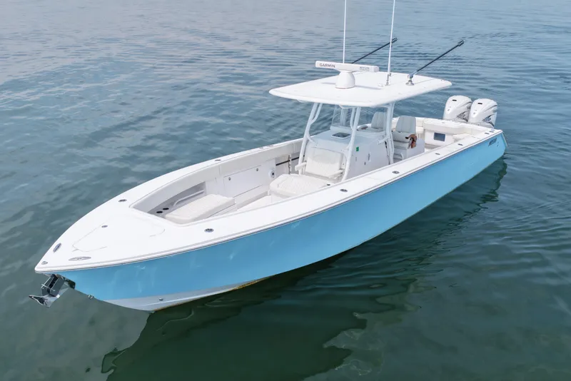 Slide: The Image of 2021 Jupiter 38 HFS boat on calm water, featuring a sleek design and twin engines. - 2