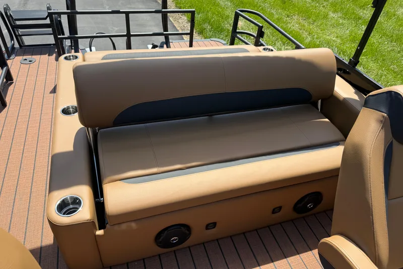 Slide: The Image of 2026 Bentley Pontoons Legacy 223 Swingback interior with tan seating and cup holders. - 20