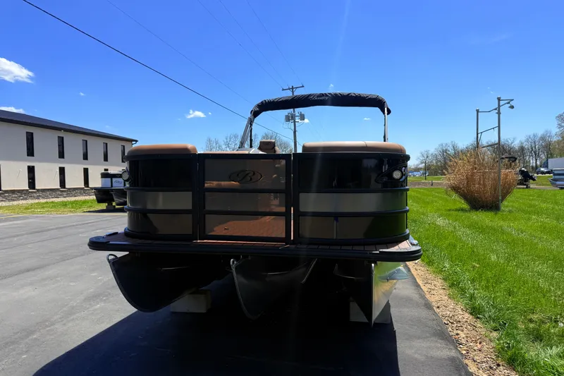 Slide: The Image of 2026 Bentley Pontoons Legacy 223 Swingback on pavement under clear blue sky. - 2