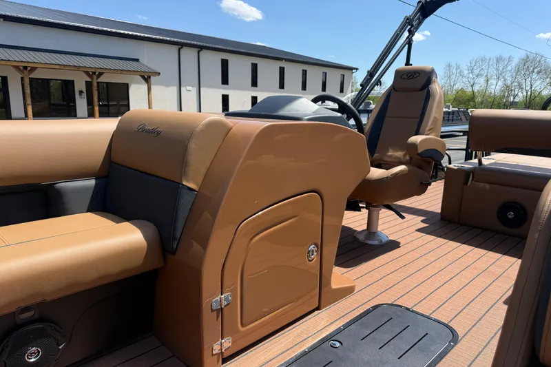 Slide: The Image of 2026 Bentley Pontoons Legacy 223 Swingback interior with tan seating and modern design. - 6