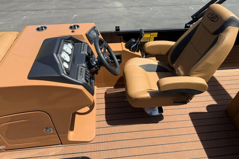 Slide: The Image of 2026 Bentley Pontoons Legacy 223 Swingback helm with tan seating and modern dashboard controls. - 15