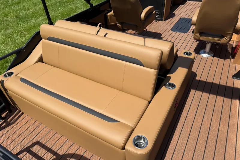 Slide: The Image of 2026 Bentley Pontoons Legacy 223 Swingback interior with tan seating and cup holders. - 24