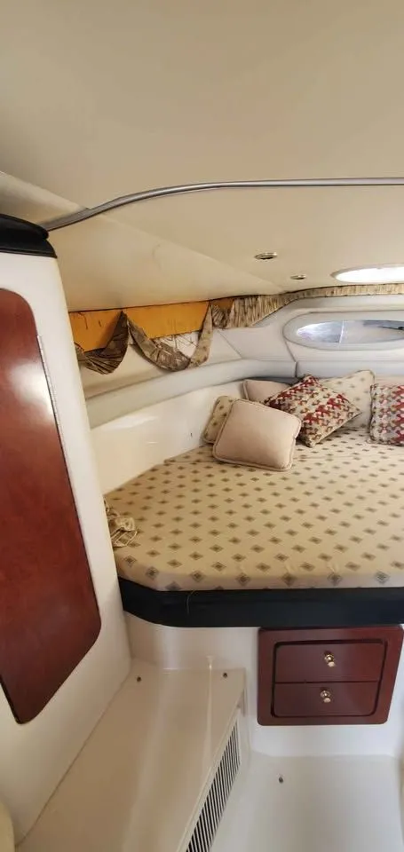 Slide: The Image of Interior of the 2002 Wellcraft 3300 Martinique with a cozy bed and decorative pillows. - 13