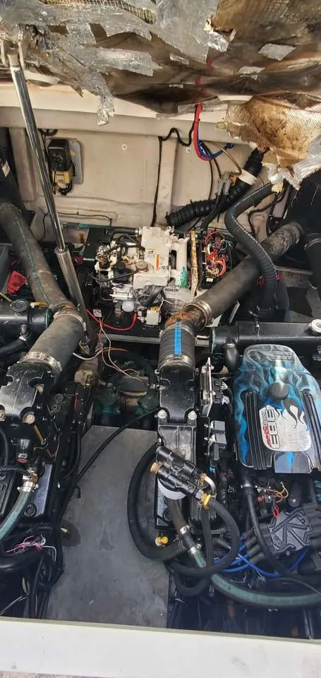 Slide: The Image of Engine room of a 2002 Wellcraft 3300 Martinique with two engines and wiring. - 18