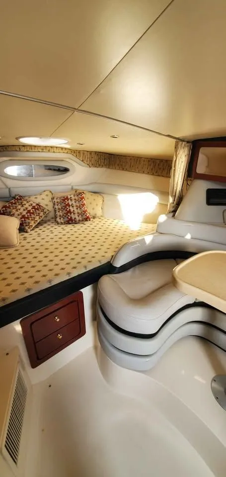 Slide: The Image of Interior of a 2002 Wellcraft 3300 Martinique with a cozy bed and seating area. - 14
