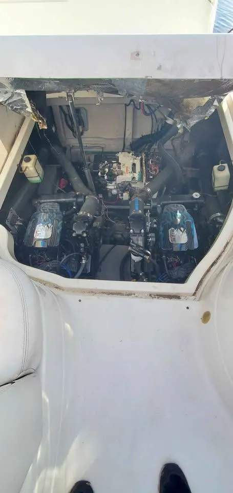 Slide: The Image of Engine compartment of a 2002 Wellcraft 3300 Martinique with dual engines and technical components. - 17