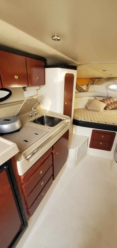 Slide: The Image of Interior of the 2002 Wellcraft 3300 Martinique with kitchen and sleeping area. - 12