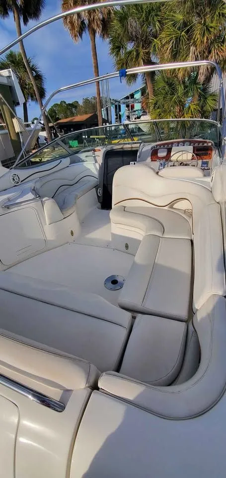 Slide: The Image of The image shows the cockpit of a 2002 Wellcraft 3300 Martinique with white upholstery. - 7