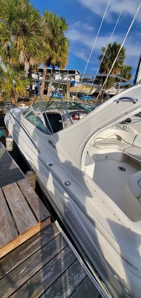 Slide: The Image of 2002 Wellcraft 3300 Martinique docked with palm trees in the background. - 4