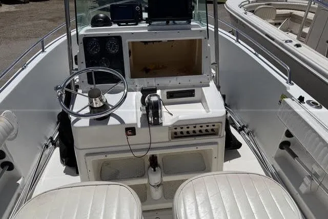 Slide: The Image of 2000 Robalo 1820 Center Console boat interior with steering wheel and controls. - 12