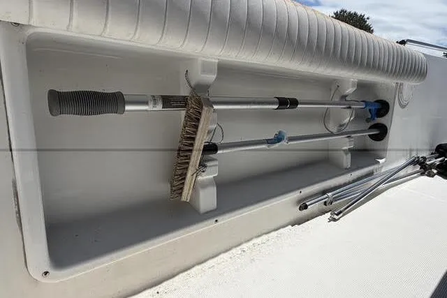 Slide: The Image of Storage compartment on a 2000 Robalo 1820 Center Console boat with cleaning tools. - 11