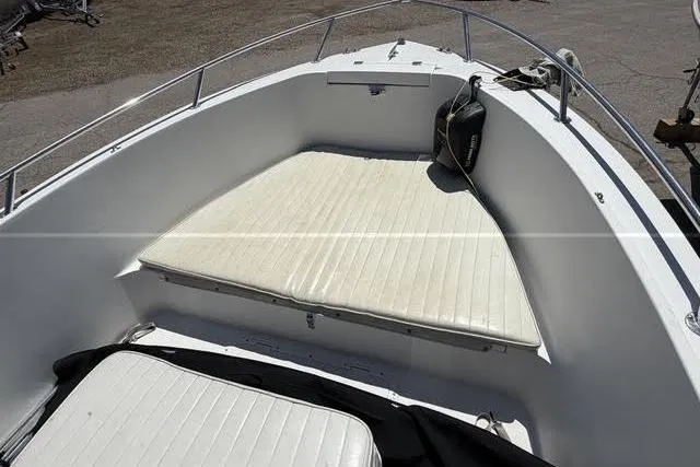 Slide: The Image of 2000 Robalo 1820 Center Console boat with cushioned seating area. - 7