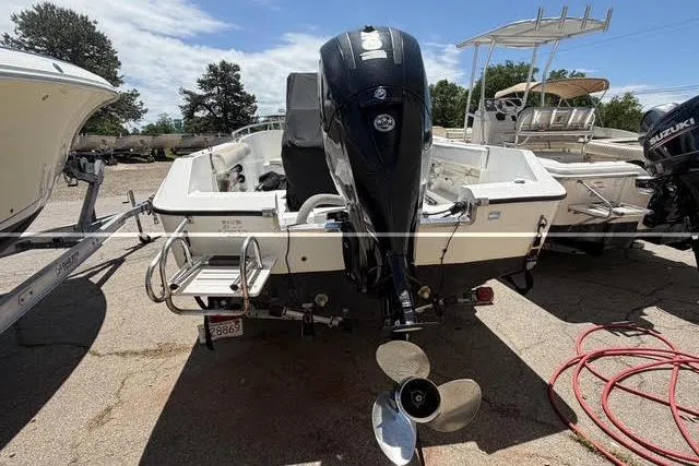 Slide: The Image of 2000 Robalo 1820 Center Console boat with outboard motor, parked on a trailer. - 4